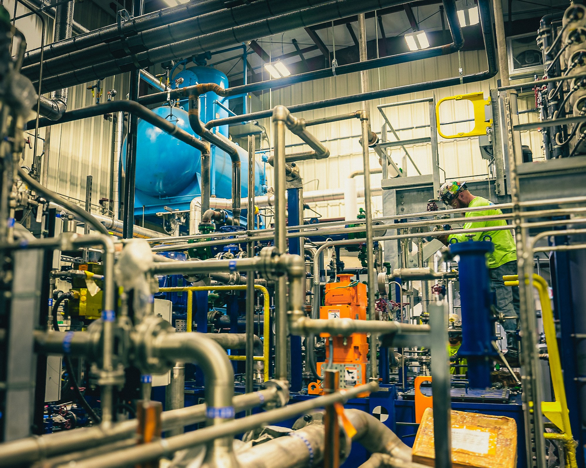 Industrial plant interior with pipework, valves and pumps during a planned maintenance shutdown